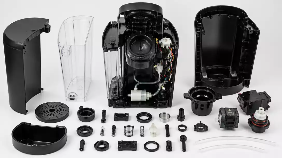 Detailed internal view of a disassembled Keurig coffee maker, showing various components for cleaning and repair.