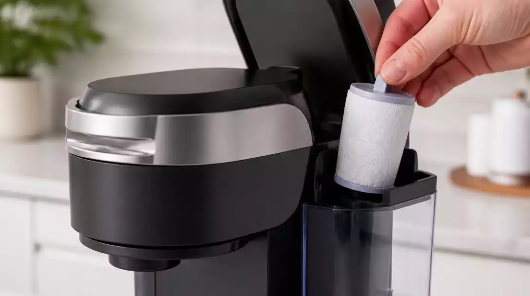 Close-up of a Keurig coffee maker with a water filter being inserted, clean and modern kitchen background, no text, no words, no typography, no labels, clean image